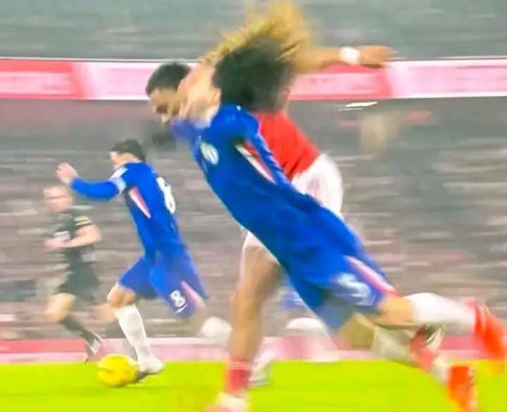 a soccer player is running towards the ball